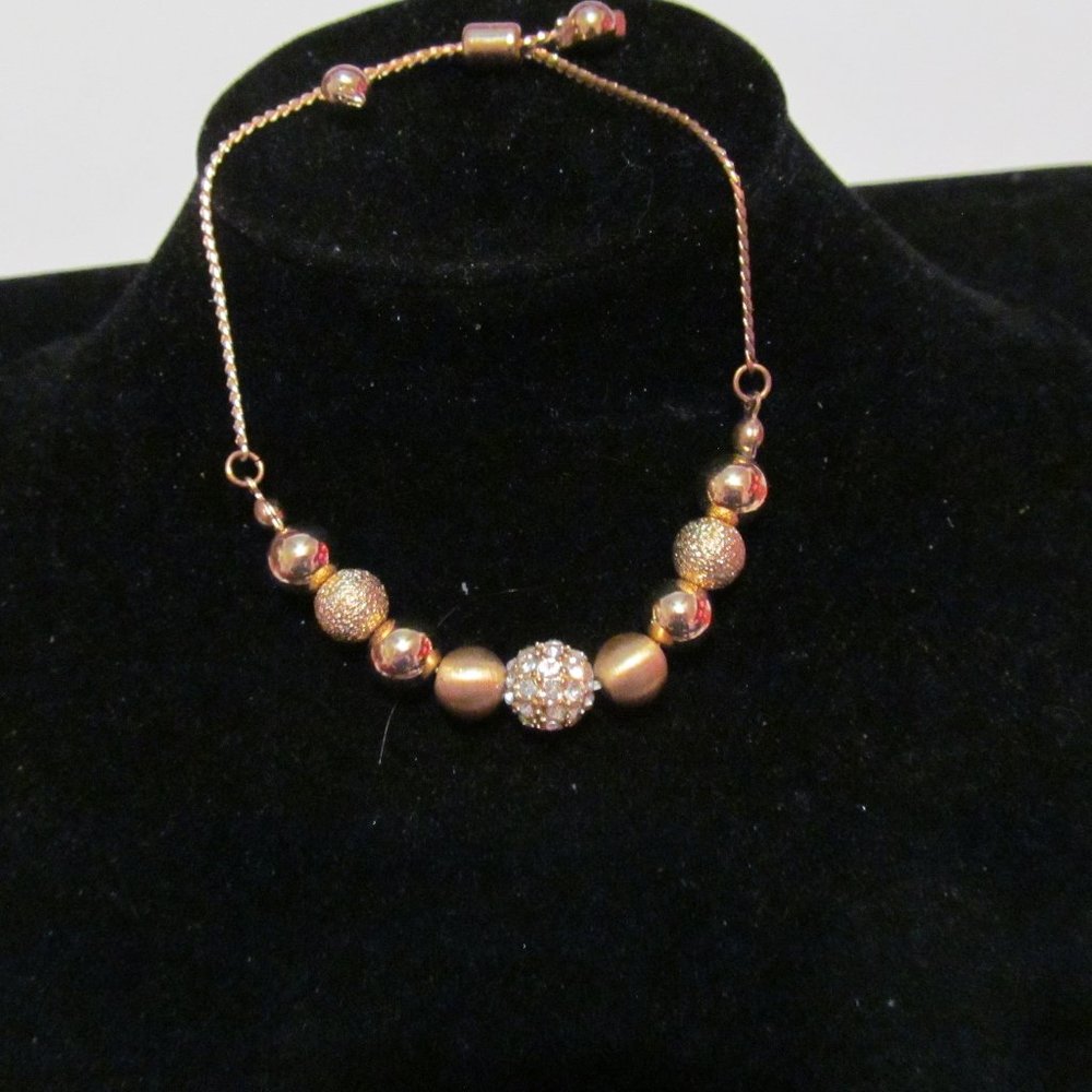 Gold tone pull tie adjustable gold bead bracelet
